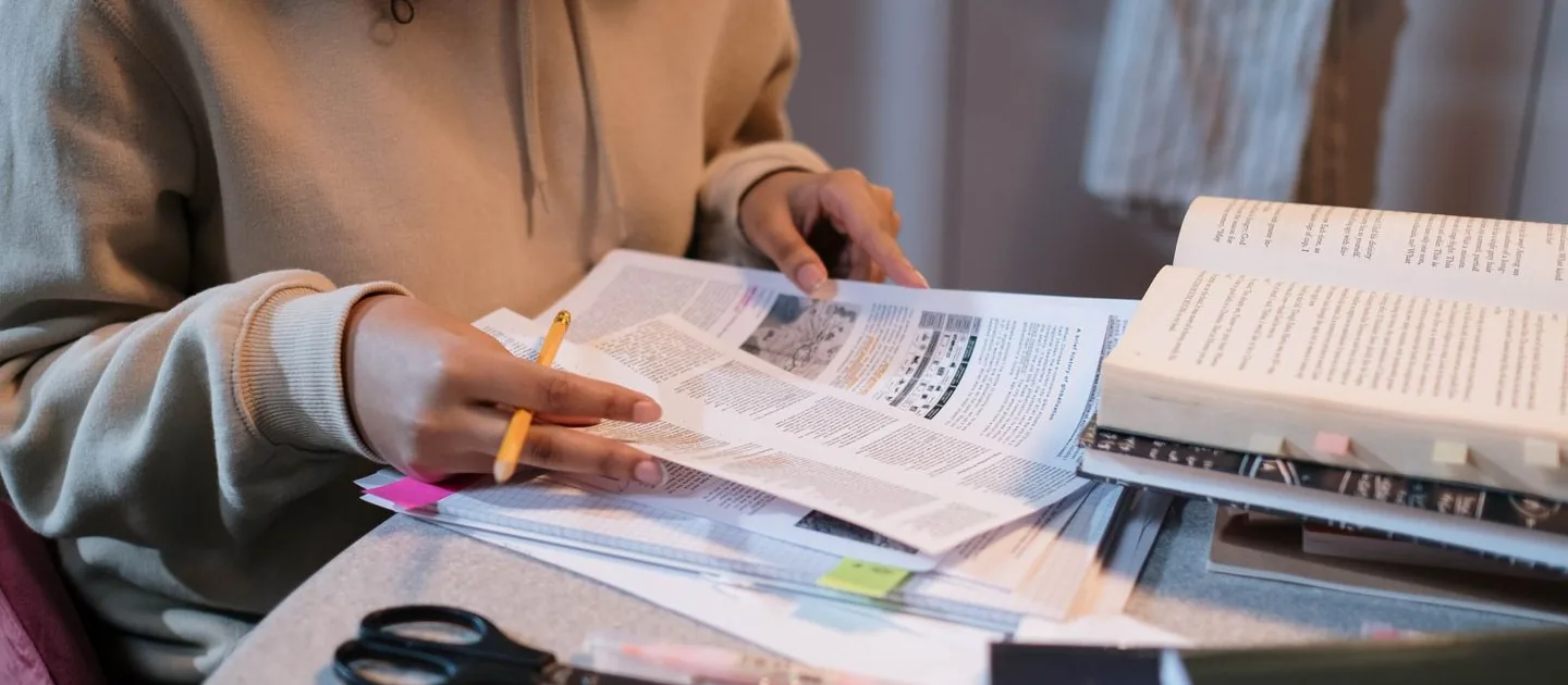 Open books, handwritten notes, and learning materials on a desk